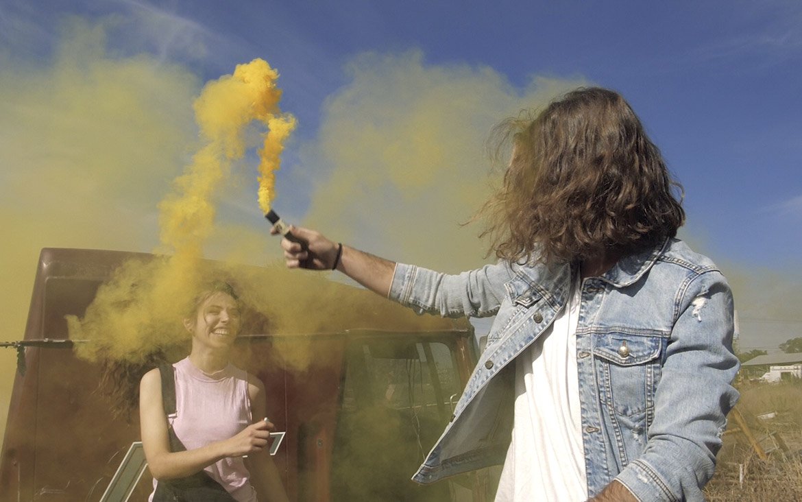 playing with a yellow smoke bomb playing with a yellow smoke bomb